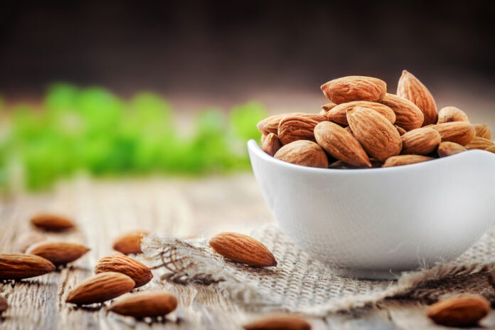 Almonds,In,White,Porcelain,Bowl,On,Wooden,Table.,Almond,Concept